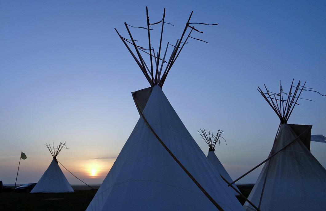 Teepees of the indigenous peoples of North America in the sunset