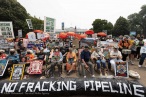 no fracking pipeline sign in front of group protesting mountain valley pipeline at the stop mv rally in washington dc